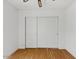 Bedroom features light hardwood floors, closet with sliding doors, and ceiling fan at 11815 N 75Th Ln, Peoria, AZ 85345