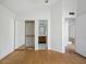 Bright bedroom with wood floors, closet, and access to other rooms at 11815 N 75Th Ln, Peoria, AZ 85345