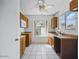Functional kitchen features wood cabinets, white appliances and a window bringing in natural light at 11815 N 75Th Ln, Peoria, AZ 85345