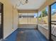 Enclosed porch area with blue carpet, multiple pane windows and a screen door at 11815 N 75Th Ln, Peoria, AZ 85345