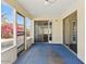 Enclosed sunroom featuring blue floors, slider doors, and views to the backyard at 11815 N 75Th Ln, Peoria, AZ 85345
