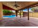 Inviting outdoor space with covered patio, fan, and view of the sparkling pool at 12436 S 38Th Pl, Phoenix, AZ 85044