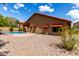 Charming backyard featuring a refreshing pool, red awnings, and low-maintenance landscaping at 12436 S 38Th Pl, Phoenix, AZ 85044