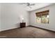 Inviting bedroom with carpet, a ceiling fan, and a large window to let in natural light at 12436 S 38Th Pl, Phoenix, AZ 85044