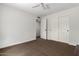 Clean bedroom with a ceiling fan, plush carpet, and a closet with sliding doors at 12436 S 38Th Pl, Phoenix, AZ 85044