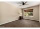 Cozy bedroom featuring neutral walls, ceiling fan, and natural light from window at 12436 S 38Th Pl, Phoenix, AZ 85044