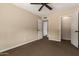 Tan bedroom with ceiling fan, carpet, and two white closet doors at 12436 S 38Th Pl, Phoenix, AZ 85044