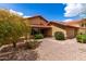 Inviting single-story home showcasing desert landscaping, large windows, and a terracotta tile roof at 12436 S 38Th Pl, Phoenix, AZ 85044