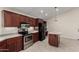 Updated kitchen features dark wood cabinets, stainless steel appliances, and a functional center island at 12436 S 38Th Pl, Phoenix, AZ 85044