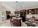 Modern kitchen with dark wood cabinets, a center island and table setting for a staged meal at 12436 S 38Th Pl, Phoenix, AZ 85044