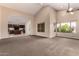 Spacious living room featuring high ceilings, large windows, and an open floor plan to the kitchen at 12436 S 38Th Pl, Phoenix, AZ 85044