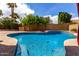 Inviting pool surrounded by lush landscaping, offering a perfect oasis for relaxation at 12436 S 38Th Pl, Phoenix, AZ 85044