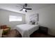 Cozy bedroom with a large window, plush bedding, and a ceiling fan for added comfort at 1302 E Maryland Ave # 15, Phoenix, AZ 85014