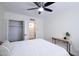 Clean bedroom features a ceiling fan, closet, and bathroom access, plus a stylish console table with decor at 1302 E Maryland Ave # 15, Phoenix, AZ 85014