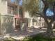 A courtyard features an outdoor seating area with an umbrella and staircases to units at 1302 E Maryland Ave # 15, Phoenix, AZ 85014