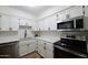 Modern kitchen featuring stainless steel appliances, white cabinetry, and granite countertops at 1302 E Maryland Ave # 15, Phoenix, AZ 85014