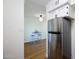 Kitchenette has stainless steel refrigerator and access to the dining area with barstools at 1302 E Maryland Ave # 15, Phoenix, AZ 85014