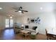 Bright living room featuring a ceiling fan, modern furnishings and three unique pieces of wall art at 1302 E Maryland Ave # 15, Phoenix, AZ 85014