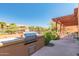 Outdoor BBQ area featuring a large grill and a pergola-covered seating area by the community pool at 13300 E Via Linda -- # 1065, Scottsdale, AZ 85259
