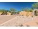 Gated community entrance with stone wall, arched entrance, desert landscaping, and clear blue sky at 13300 E Via Linda -- # 1065, Scottsdale, AZ 85259