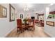 Dining room with a glass table and ornate chairs, open to the living room at 13300 E Via Linda -- # 1065, Scottsdale, AZ 85259