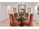 Dining room showcases a glass table with upholstered chairs and wood floors at 13300 E Via Linda -- # 1065, Scottsdale, AZ 85259
