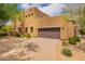 Exterior view of a modern stucco house with a two-car garage and mature landscaping at 13300 E Via Linda -- # 1065, Scottsdale, AZ 85259
