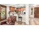 Open concept eat-in kitchen featuring stainless steel appliances, wood cabinets, and bar seating at 13300 E Via Linda -- # 1065, Scottsdale, AZ 85259