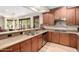 Well-lit eat-in kitchen area featuring stainless steel appliances, wood cabinets, and granite countertops at 13300 E Via Linda -- # 1065, Scottsdale, AZ 85259