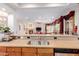 Open kitchen area with a stainless steel sink and appliances overlooks the living room at 13300 E Via Linda -- # 1065, Scottsdale, AZ 85259