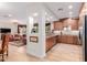 Open concept kitchen and living room with wood cabinets, stainless steel appliances, and neutral color palette at 13300 E Via Linda -- # 1065, Scottsdale, AZ 85259