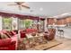 Living room with a view of the kitchen and bar, featuring hardwood floors and classic decor at 13300 E Via Linda -- # 1065, Scottsdale, AZ 85259