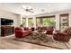 Comfortable living room area featuring plush sofas, a ceiling fan, modern decor, and wood flooring at 13300 E Via Linda -- # 1065, Scottsdale, AZ 85259