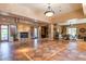 Expansive lounge with fireplace, tile floors, multiple seating areas and outdoor access at 13300 E Via Linda -- # 1065, Scottsdale, AZ 85259