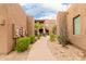 A walkway between buildings features lush landscaping and staircase to upper units at 13300 E Via Linda -- # 1065, Scottsdale, AZ 85259