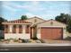 Charming single-story home with a two-car garage, terracotta tile roof, and inviting desert landscaping at 141 N 175Th Ave, Goodyear, AZ 85338