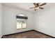 Bright bedroom with wood floors, ceiling fan, window, and trim at 1437 W Renee Dr, Phoenix, AZ 85027