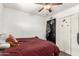 Bedroom featuring a ceiling fan, window, closet, and bed with Chiefs-themed decor at 1437 W Renee Dr, Phoenix, AZ 85027