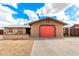 Charming single-story home with a bright red garage door and low-maintenance desert landscaping at 1437 W Renee Dr, Phoenix, AZ 85027