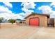 Single-story home with an attached garage and a spacious driveway with desert landscaping at 1437 W Renee Dr, Phoenix, AZ 85027
