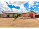 Single-story home featuring a well-manicured lawn, arched windows, and a spacious yard at 1437 W Renee Dr, Phoenix, AZ 85027