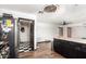 Kitchen with black cabinets and stainless steel appliances, with view to the dining and living rooms at 1437 W Renee Dr, Phoenix, AZ 85027