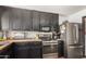 Kitchen featuring black cabinetry, butcher block counters, stainless steel appliances, and wood-look flooring at 1437 W Renee Dr, Phoenix, AZ 85027