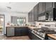 Updated kitchen features black cabinetry, butcher block counters, stainless steel appliances, and wood-look flooring at 1437 W Renee Dr, Phoenix, AZ 85027