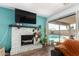 Cozy living room with a brick fireplace, stylish decor, and a view of the refreshing pool at 1437 W Renee Dr, Phoenix, AZ 85027