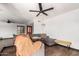 Comfortable living room features a large sectional couch, ceiling fans, and a brightly colored front door at 1437 W Renee Dr, Phoenix, AZ 85027