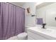 Well-lit bathroom with a shower and tub combo, updated sink and fixtures, and a stylish purple color scheme at 1475 E Avenida Kino --, Casa Grande, AZ 85122