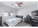 A well-lit bedroom featuring a ceiling fan, large window, and a bed with a floral comforter at 1475 E Avenida Kino --, Casa Grande, AZ 85122