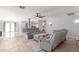 Bright living room featuring modern furniture, a ceiling fan, and tile floors throughout, bathed in natural light at 1475 E Avenida Kino --, Casa Grande, AZ 85122
