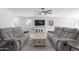 Bright living room featuring modern furniture, a ceiling fan, and tile floors throughout, bathed in natural light at 1475 E Avenida Kino --, Casa Grande, AZ 85122